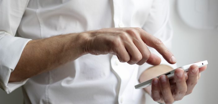 person holding white Android smartphone in white shirt